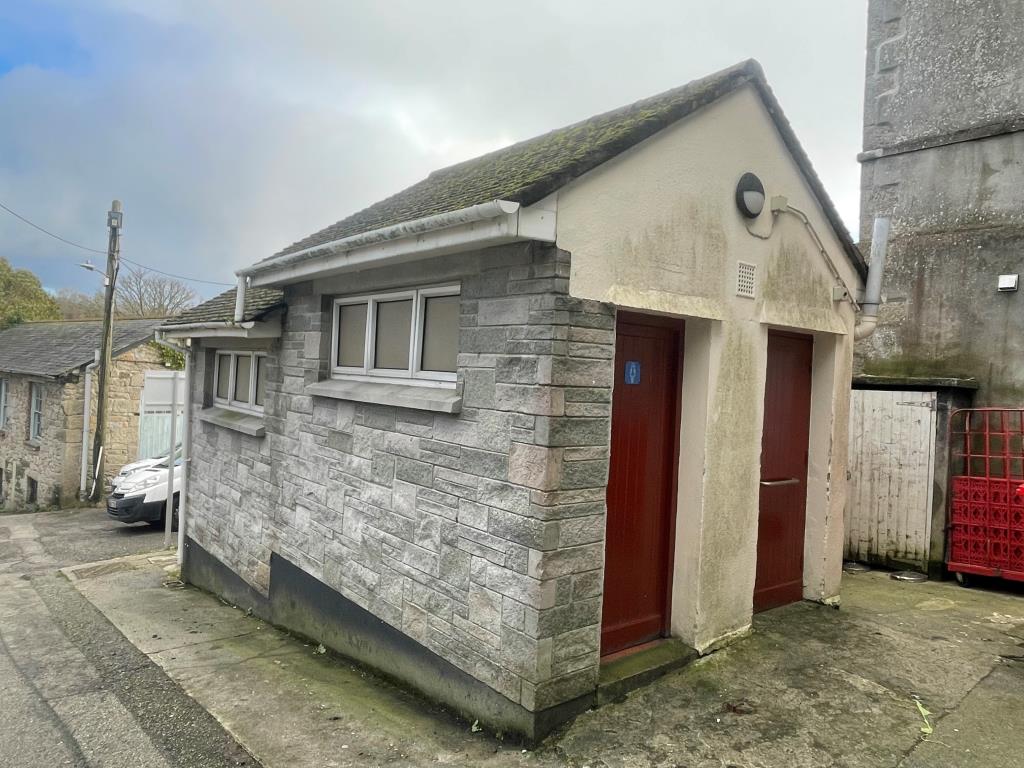 Lot: 140 - FORMER PUBLIC CONVENIENCES - Exterior of toilet block showing access points to ladies and the accessible toilet cubicles